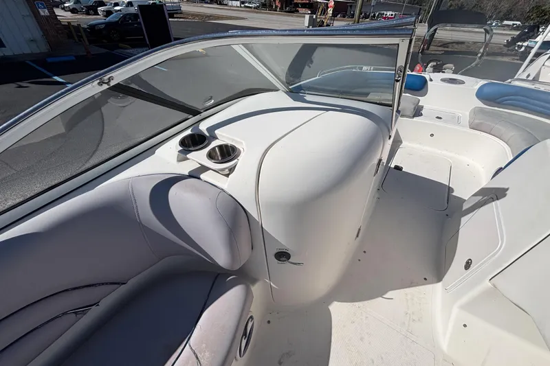 Slide: The Image of 2006 Hurricane SunDeck 217 OB boat interior with seating and cup holders. - 11