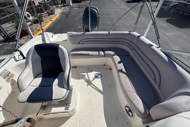 Slide: The Image of 2006 Hurricane SunDeck 217 OB boat interior with seating and steering chair. - 15