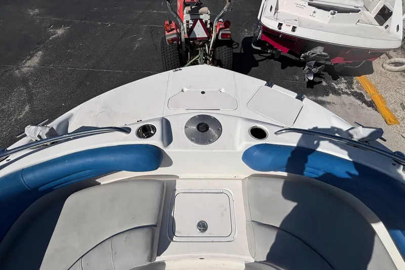 Slide: The Image of 2006 Hurricane SunDeck 217 OB boat interior with blue seating and cup holders. - 19
