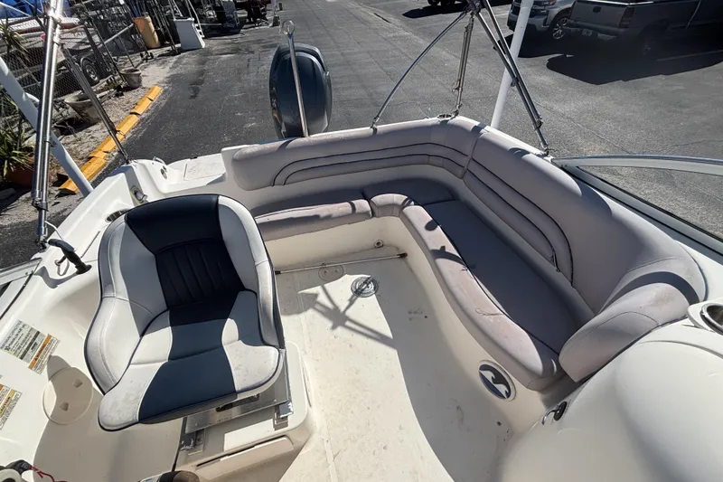 Slide: The Image of 2006 Hurricane SunDeck 217 OB boat interior with seating and steering wheel. - 22