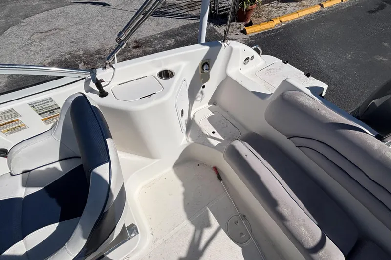 Slide: The Image of 2006 Hurricane SunDeck 217 OB boat interior with seating and storage compartments. - 23