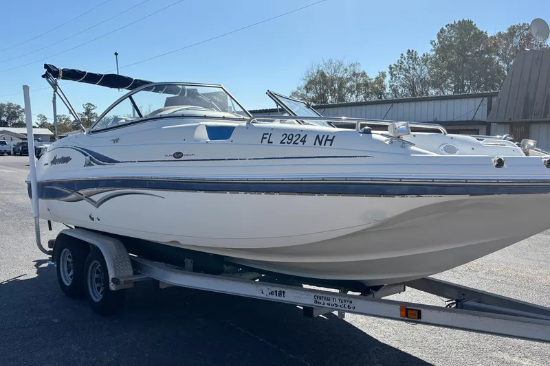 Slide: The Image of 2006 Hurricane SunDeck 217 OB boat on trailer, parked outdoors. - 4