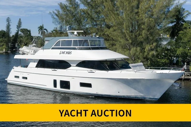The Image of 2017 Ocean Alexander 85 E yacht in auction, docked on a serene waterway. - 0
