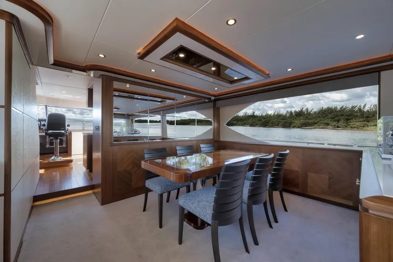 Slide: The Image of Luxurious dining area on 2017 Ocean Alexander 85 E yacht with scenic water views. - 11
