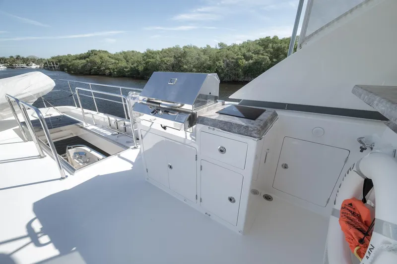 Slide: The Image of Outdoor kitchen on 2017 Ocean Alexander 85 E yacht with grill and storage, near waterway. - 20