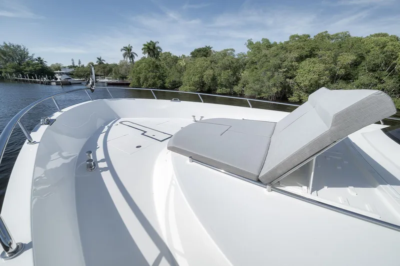 Slide: The Image of Luxurious 2017 Ocean Alexander 85 E yacht with sunbed on deck, surrounded by lush greenery. - 24