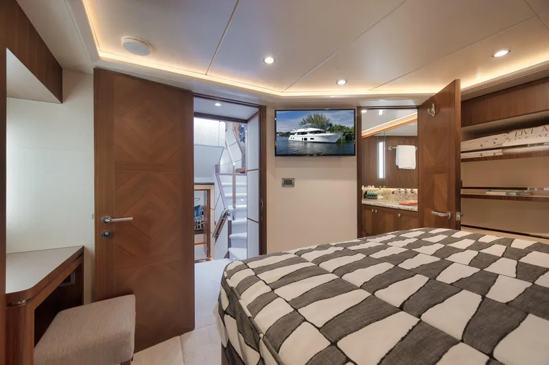 Slide: The Image of Luxurious 2017 Ocean Alexander 85 E yacht bedroom with modern decor and amenities. - 30