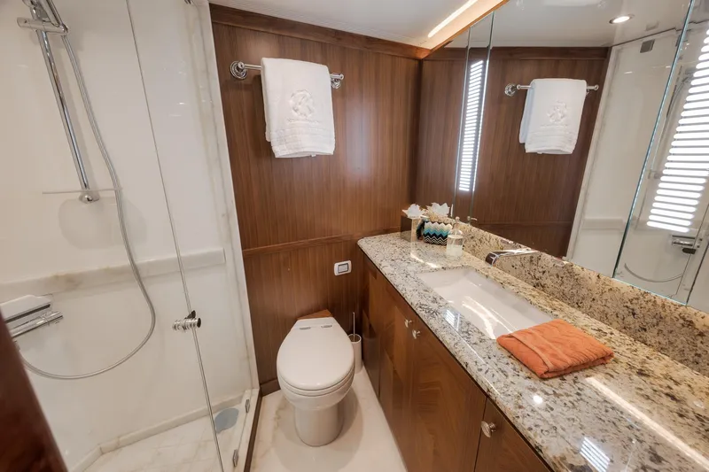 Slide: The Image of Luxurious bathroom in 2017 Ocean Alexander 85 E yacht with granite countertop and glass shower. - 32