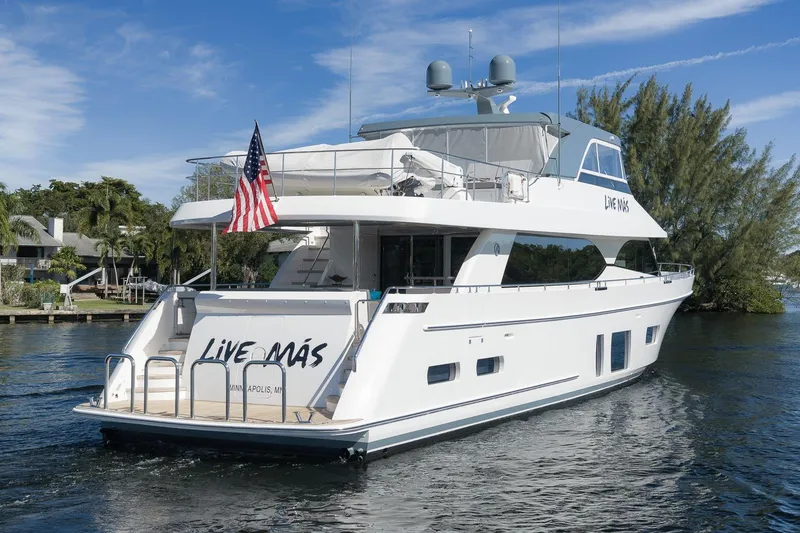 Slide: The Image of Luxury 2017 Ocean Alexander 85 E yacht on water, featuring "Live Más" and American flag. - 37
