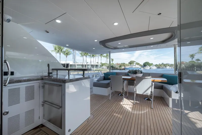 Slide: The Image of Luxurious 2017 Ocean Alexander 85 E yacht deck with elegant seating and scenic waterfront view. - 7