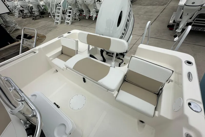 Slide: The Image of 2026 Bulls Bay 2200 XS boat interior with seating and Suzuki outboard motor. - 13