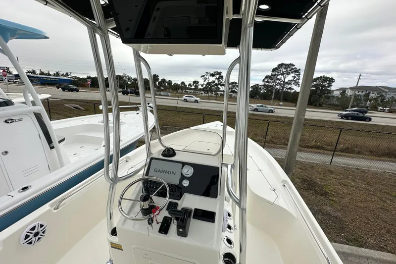 Slide: The Image of 2026 Bulls Bay 2200 XS boat with Garmin navigation, parked near a road. - 4