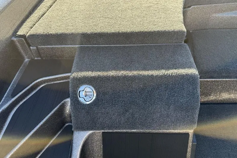 Slide: The Image of 2026 Skeeter ZXE20 boat interior with carpeted storage compartment and lock. - 10