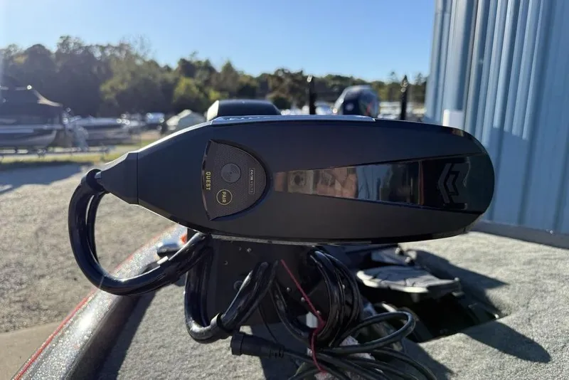 Slide: The Image of 2026 Skeeter ZXE20 boat control panel with cables, outdoors in a marina setting. - 11