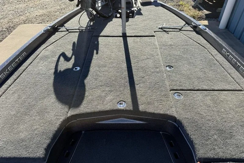 Slide: The Image of 2026 Skeeter ZXE20 boat deck with carpeted surface and storage compartments. - 12