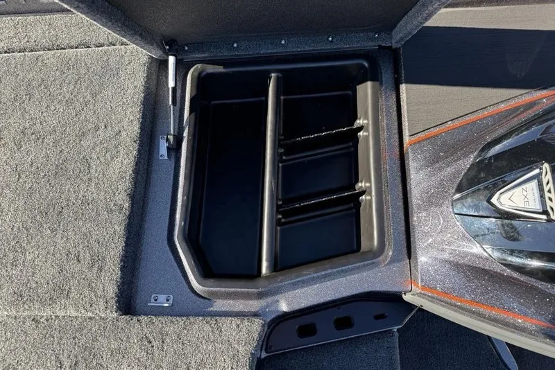 Slide: The Image of 2026 Skeeter ZXE20 boat storage compartment with carpeted interior and sleek design. - 13
