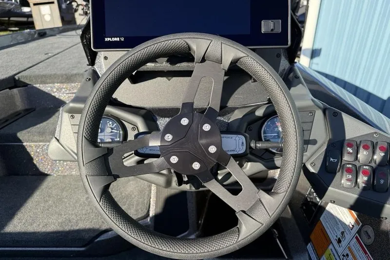 Slide: The Image of Steering wheel of 2026 Skeeter ZXE20 boat with dashboard controls and display. - 16