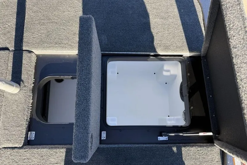 Slide: The Image of 2026 Skeeter ZXE20 boat storage compartments with open hatches, showcasing interior design. - 23