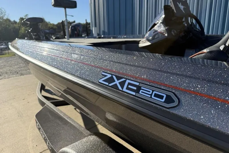 Slide: The Image of 2026 Skeeter ZXE20 boat with sleek design and metallic finish, parked outdoors. - 4