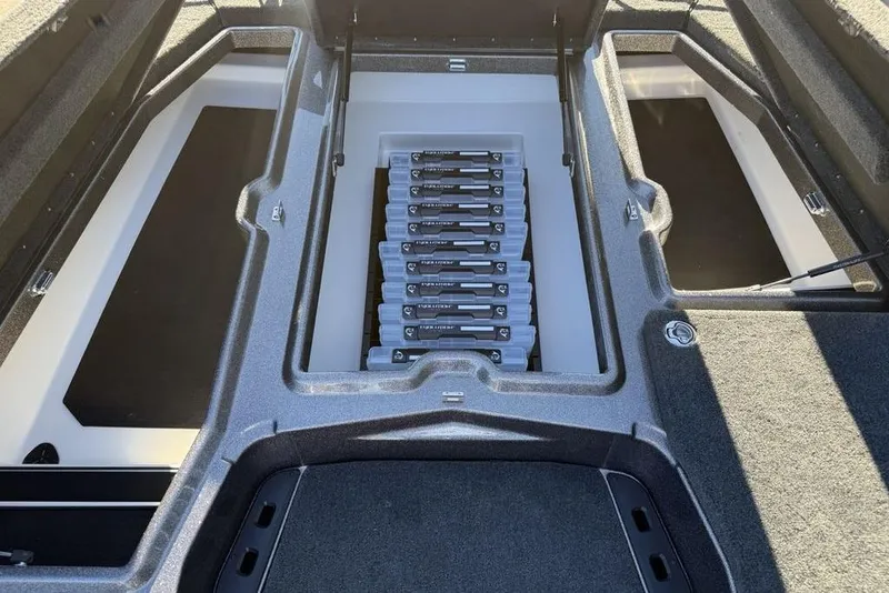 Slide: The Image of Storage compartments of 2026 Skeeter ZXE20 boat, featuring organized tackle boxes. - 9