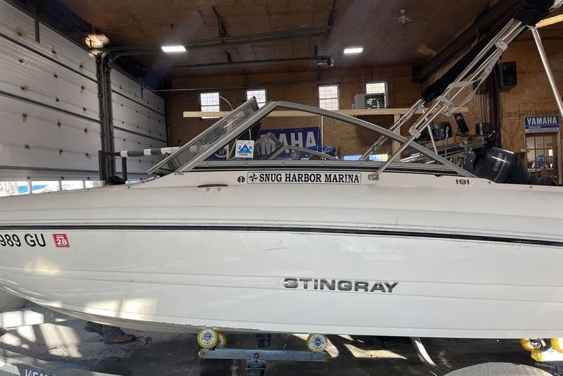 Slide: The Image of 2016 Stingray 191 DC boat in marina garage, side view. - 12