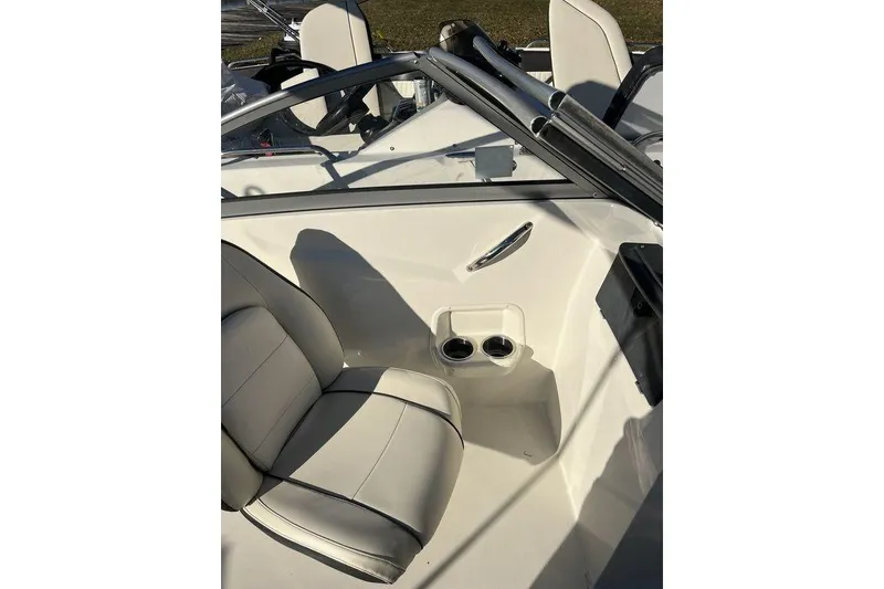 Slide: The Image of 2016 Stingray 191 DC boat interior with white seating and cup holders. - 5