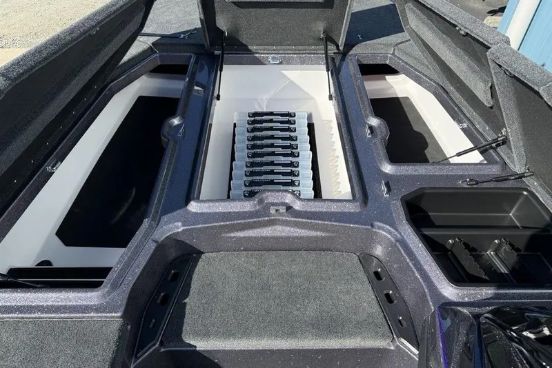 Slide: The Image of 2026 Skeeter ZXE21 boat interior with open storage compartments and organized tackle trays. - 10