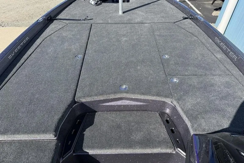 Slide: The Image of 2026 Skeeter ZXE21 boat deck with gray carpet and storage compartments. - 13