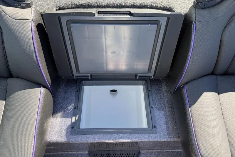 Slide: The Image of 2026 Skeeter ZXE21 boat interior with open storage compartment between seats. - 19