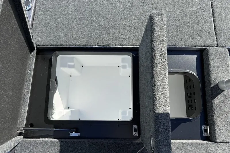 Slide: The Image of 2026 Skeeter ZXE21 boat storage compartments with open lids, showcasing interior space. - 24