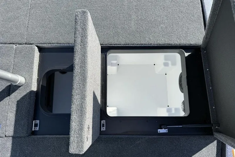 Slide: The Image of 2026 Skeeter ZXE21 boat storage compartments with open lids, showcasing interior space. - 25