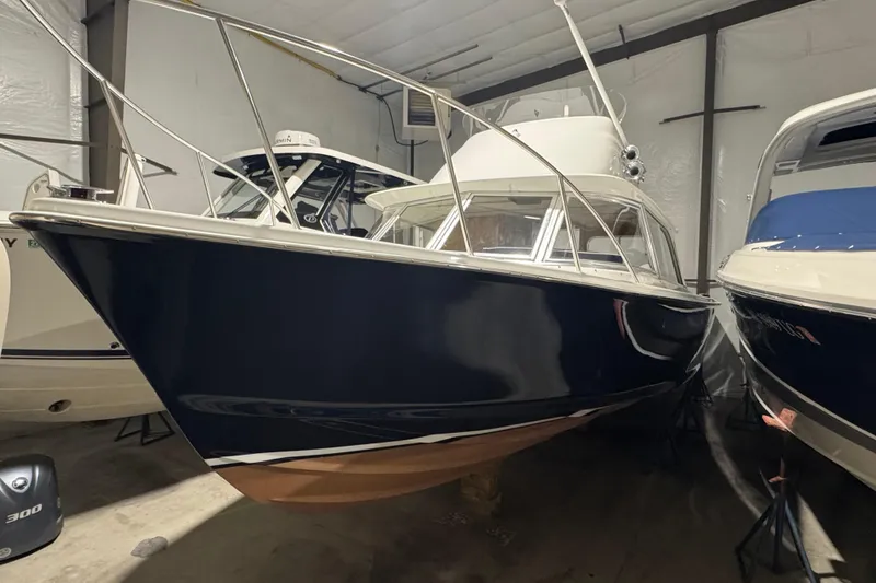 The Image of 1974 Bertram 31 Flybridge Cruiser in storage, showcasing classic design and sleek lines. - 0