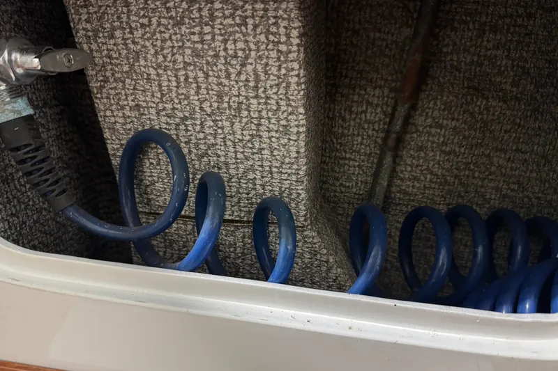 Slide: The Image of Coiled blue hose in 1974 Bertram 31 Flybridge Cruiser interior. - 12