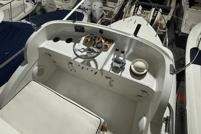 Slide: The Image of 1974 Bertram 31 Flybridge Cruiser helm with steering wheel and controls. - 13