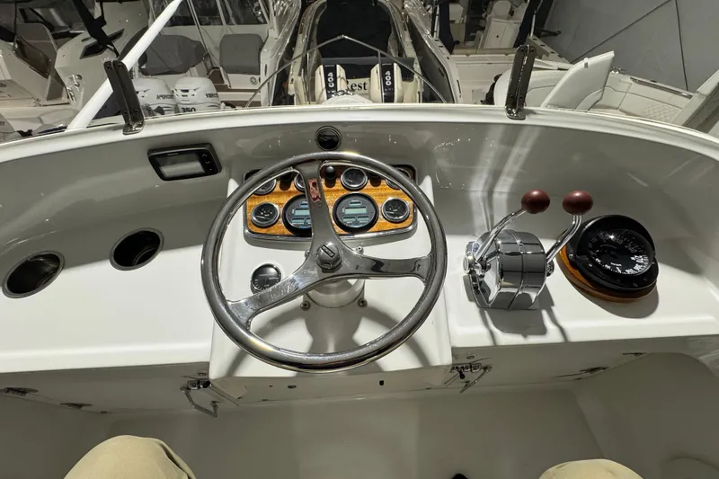 Slide: The Image of 1974 Bertram 31 Flybridge Cruiser helm with steering wheel, gauges, and controls. - 14