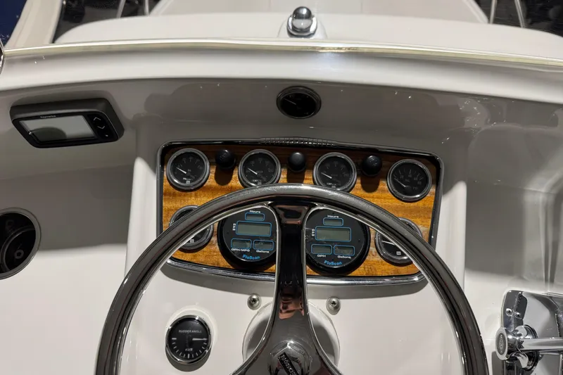 Slide: The Image of 1974 Bertram 31 Flybridge Cruiser dashboard with gauges and steering wheel. - 17