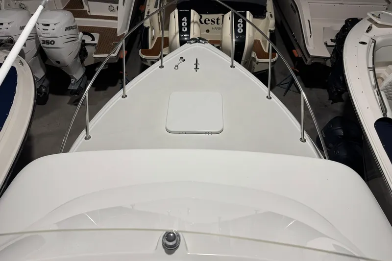 Slide: The Image of 1974 Bertram 31 Flybridge Cruiser, top view, docked among other boats. - 19