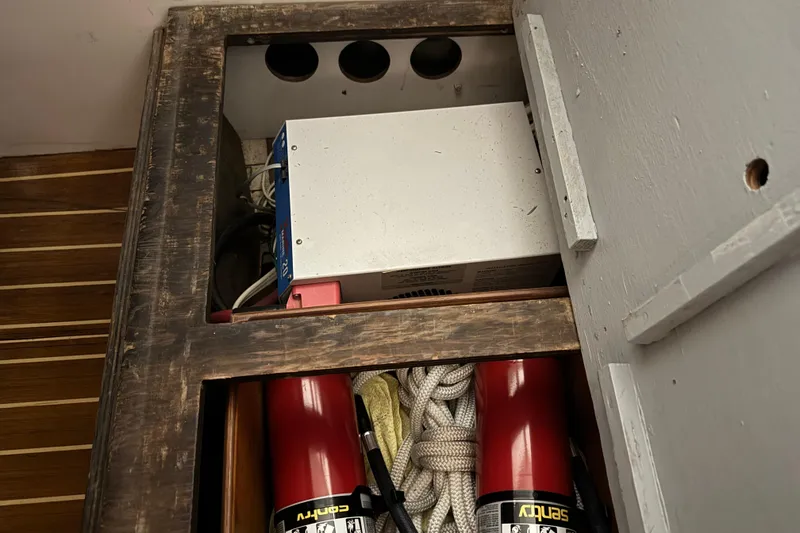 Slide: The Image of Storage compartment in a 1974 Bertram 31 Flybridge Cruiser with equipment and ropes. - 23