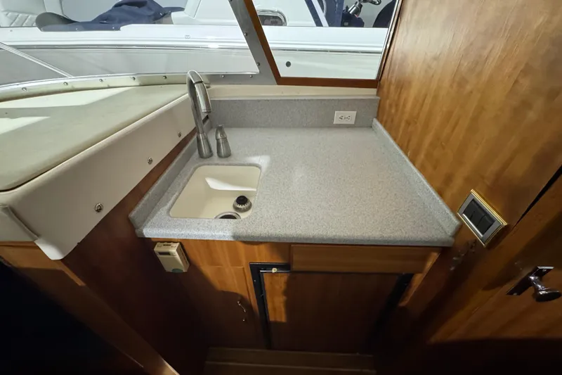 Slide: The Image of 1974 Bertram 31 Flybridge Cruiser interior with compact sink and countertop. - 27