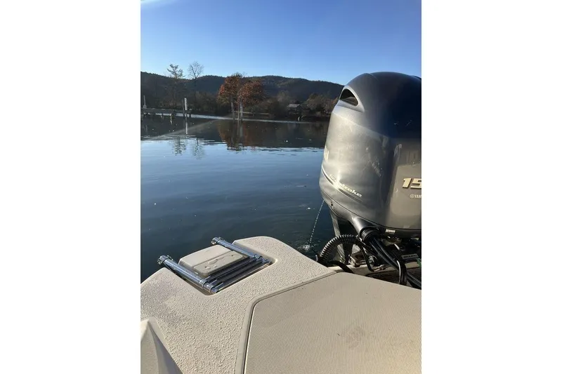 Slide: The Image of 2016 Stingray 192 SC boat with Yamaha outboard motor on a serene lake. - 13