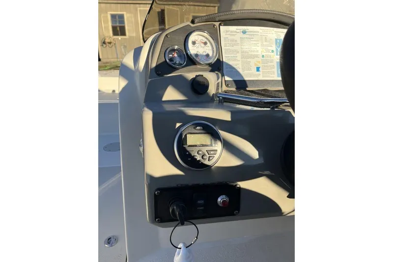 Slide: The Image of 2016 Stingray 192 SC boat dashboard with gauges and controls in sunlight. - 15