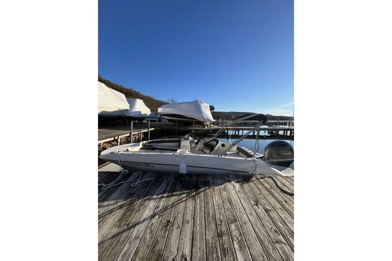 Slide: The Image of 2016 Stingray 192 SC boat docked on a sunny day with clear blue sky. - 4