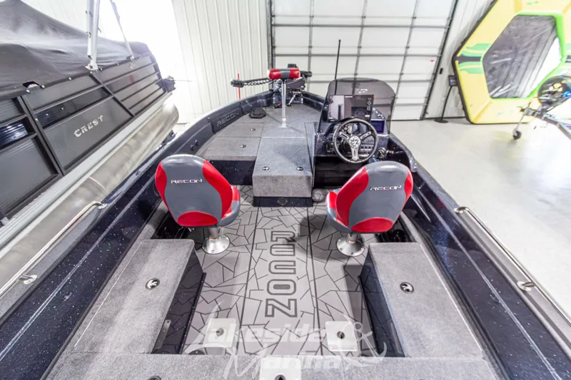 Slide: The Image of Interior of 2026 Recon 895 SC boat with red seats and modern dashboard. - 11