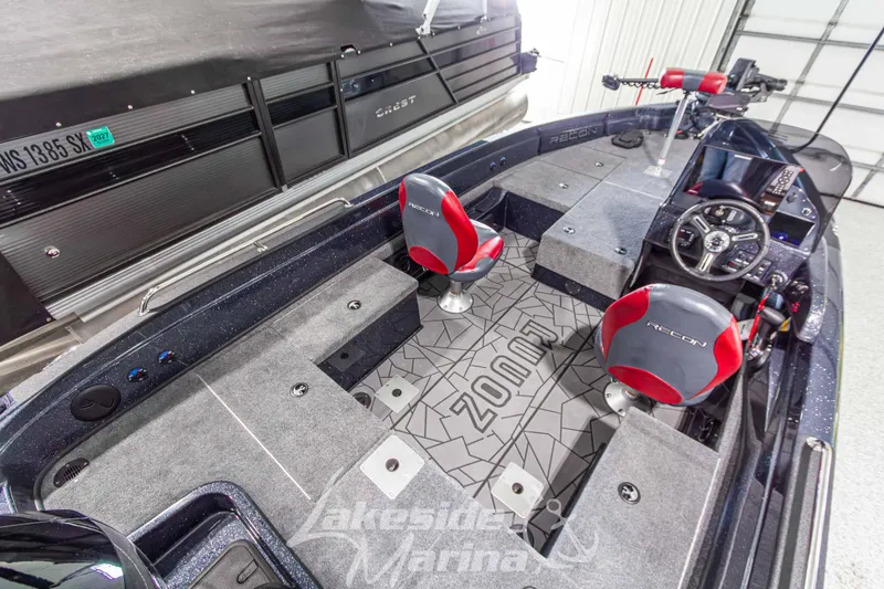 Slide: The Image of Interior of 2026 Recon 895 SC boat with red and gray seating, modern dashboard. - 12