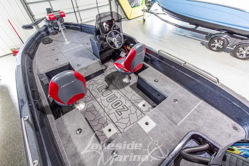 Slide: The Image of 2026 Recon 895 SC boat interior with red seats and modern dashboard in showroom. - 13