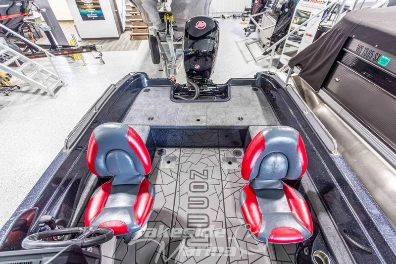 Slide: The Image of 2026 Recon 895 SC boat interior with red and gray seats, motor, and branded flooring. - 14
