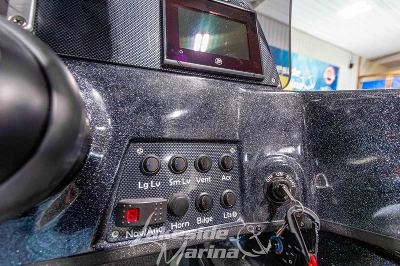 Slide: The Image of Control panel of 2026 Recon 895 SC boat with switches and ignition key. - 19