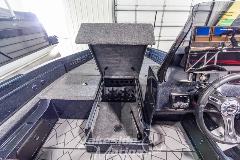 Slide: The Image of Interior of 2026 Recon 895 SC boat with open storage compartment and modern dashboard. - 25