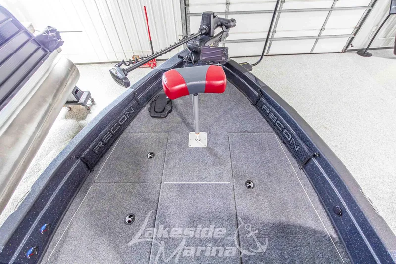 Slide: The Image of 2026 Recon 895 SC boat interior with red seat and trolling motor in garage. - 26
