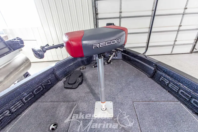 Slide: The Image of 2026 Recon 895 SC boat interior with red and black seat, carpeted floor, and branded details. - 28